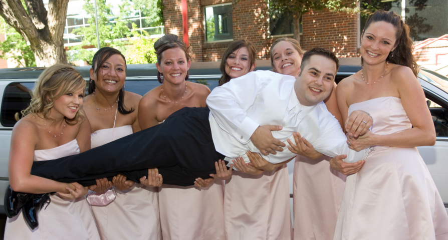 Groom held by bridesmaids